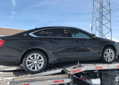 black car on tow truck